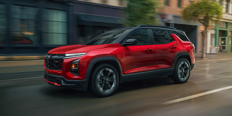 A vibrant 2026 Chevrolet Equinox cruising through an urban street with sleek design and modern features.