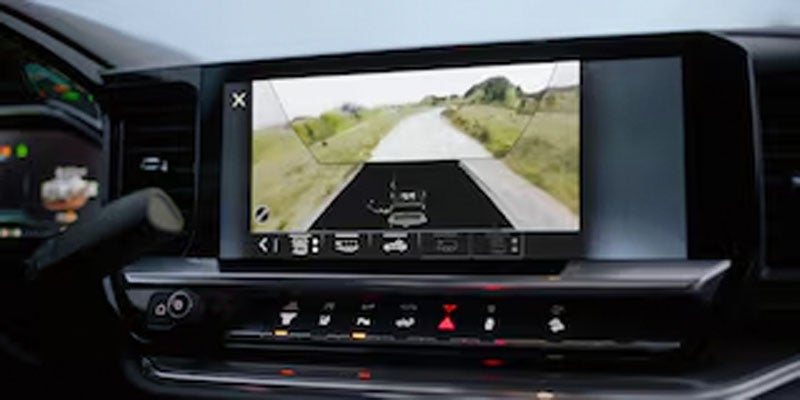 Chevrolet Silverado infotainment screen showing rearview camera with towing guidelines.