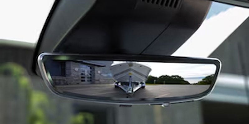 View of a boat reflected in the Chevrolet Silverado rearview mirror.