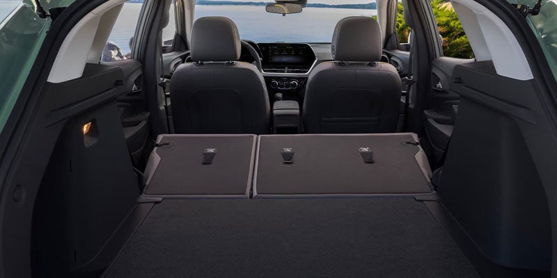 2026 Chevrolet Trax interior with rear seats folded down, offering ample cargo space.